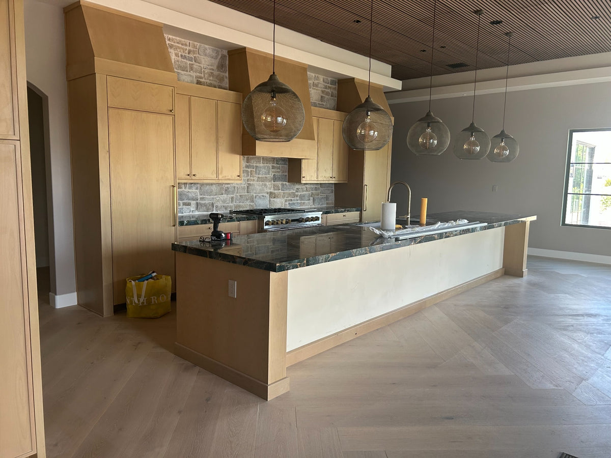 Luxury custom kitchen cabinetry with stone and wood detailing