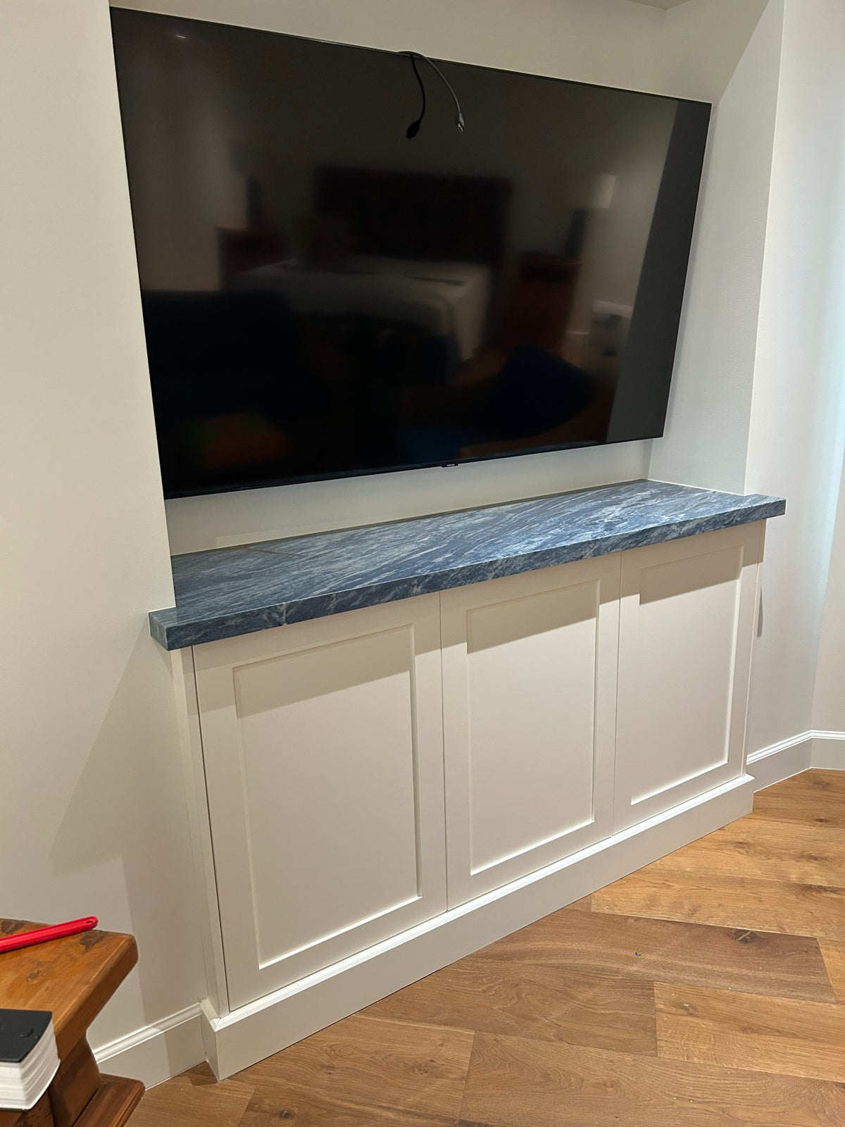 Custom media cabinetry with stone top in a luxury residence