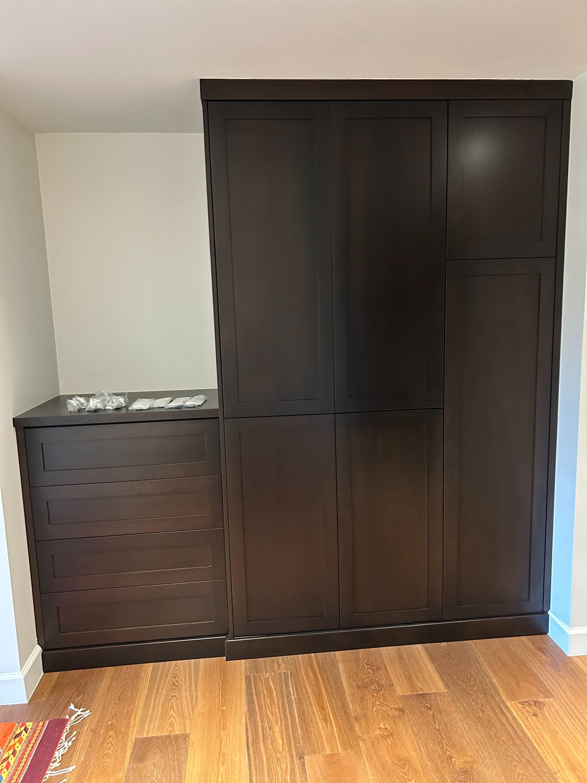 Dark custom built-in cabinetry with integrated storage
