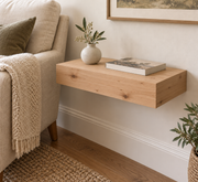 18-inch long, 3-inch thick unfinished knotty alder floating shelf, standard mount, unlit reading-room rendering