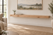 Gentry Stinson Knotty Alder Floating Shelf | 54″ long × 3″ thick | Standard Mount | Unfinished — unlit living-room rendering