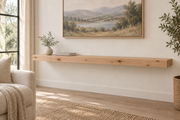 Gentry Stinson Knotty Alder Floating Shelf | 60″ long × 3″ thick | Standard Mount | Unfinished — unlit living-room rendering