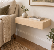 18-inch long, 3-inch thick natural maple floating shelf, standard mount, unlit, in a living room