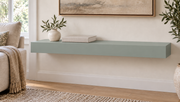 30-inch long, 3-inch thick standard painted floating shelf in Halcyon Green SW 6213, unlit living-room rendering.