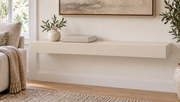 30-inch long, 3-inch thick standard painted floating shelf in Natural Linen SW 9109, unlit living-room rendering.