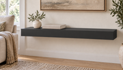 30-inch long, 3-inch thick standard painted floating shelf in Tricorn Black SW 6258, unlit living-room rendering.