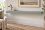 48-inch long, 3-inch thick standard painted floating shelf in Halcyon Green SW 6213, unlit living-room rendering.