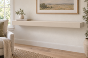 48-inch long, 3-inch thick standard painted floating shelf in Natural Linen SW 9109, unlit living-room rendering.