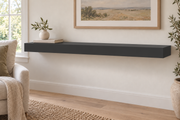 48-inch long, 3-inch thick standard painted floating shelf in Tricorn Black SW 6258, unlit living-room rendering.