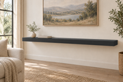 60-inch long, 3-inch thick standard painted floating shelf in Tricorn Black SW 6258, unlit living-room rendering.