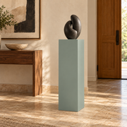 Titan 12 × 16 × 42 inch painted pedestal in Halcyon Green SW 6213, styled with artwork.