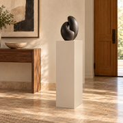 Titan 12 × 16 × 42 inch painted pedestal in Natural Linen SW 9109, styled with artwork.
