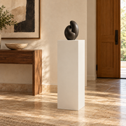 Titan 16 × 16 × 36 inch painted pedestal in Alabaster SW 7008, styled with artwork.