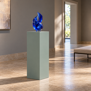 Titan 16 × 16 × 36 inch painted pedestal in Halcyon Green SW 6213, styled with artwork.