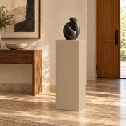 Titan 16 × 16 × 36 inch painted pedestal in Universal Khaki SW 6150, styled with artwork.