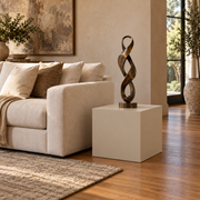 Titan 20 × 20 × 24 inch painted pedestal in Universal Khaki SW 6150, styled with artwork.