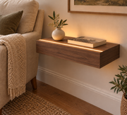 18-inch long, 3-inch thick natural walnut floating shelf, standard mount, LED-ready Top Front location shown with separately supplied lighting, living-room rendering
