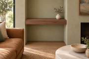 24-inch long, 3-inch thick natural walnut floating shelf, wall-to-wall mount, unlit, living-room rendering