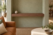 30-inch long, 3-inch thick natural walnut floating shelf, wall-to-wall mount, unlit, living-room rendering
