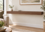 42-inch long, 3-inch thick natural walnut floating shelf, standard mount, unlit, living-room rendering