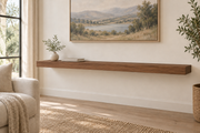 60-inch long, 3-inch thick natural walnut floating shelf, standard mount, unlit, living-room rendering