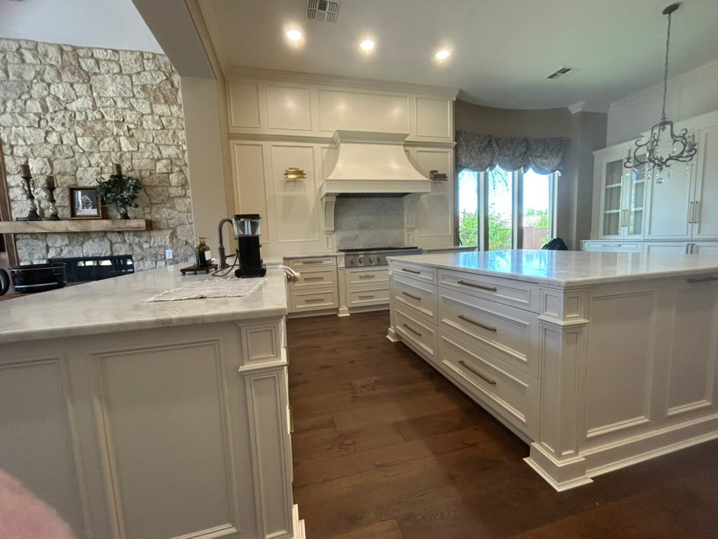 Custom white kitchen cabinetry with island and architectural millwork