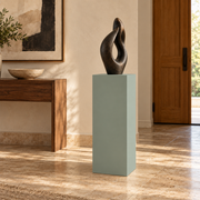 Titan painted display pedestal, 11 × 11 × 30 inches, Halcyon Green SW 6213. Styled setting; artwork not included.