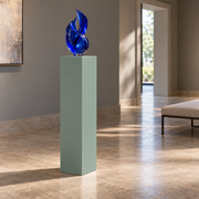Titan painted display pedestal, 11 × 11 × 36 inches, Halcyon Green SW 6213. Styled setting; artwork not included.