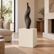 Creamy SW 7012 painted display pedestal in a 02 low living room setting; representative room rendering.