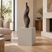 Worldly Gray SW 7043 painted display pedestal in a 02 low living room setting; representative room rendering.