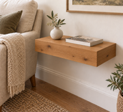 Knotty Alder floating shelf in Rubio Monocoat Bourbon, Standard mount; unlit representative compact-proportion room rendering, not dimension-specific.
