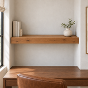Knotty Alder floating shelf in Rubio Monocoat Bourbon, Wall to Wall mount; unlit representative medium-proportion room rendering, not dimension-specific.